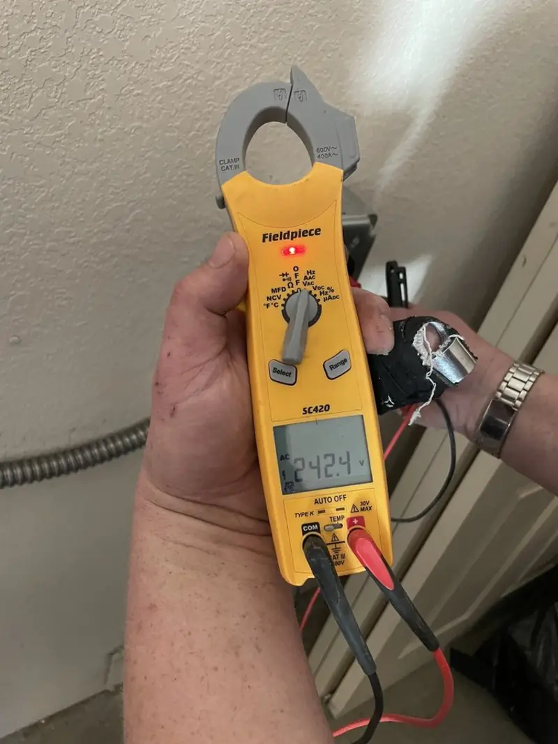 Voltage testing with clamp meter during Outlet Installation in Perry